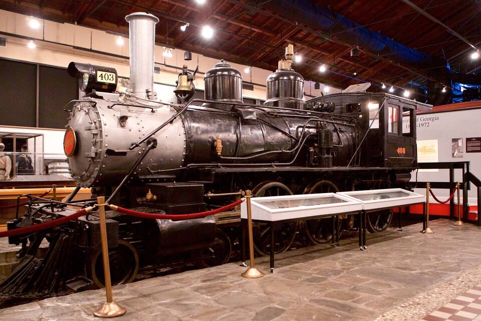 A steam locomotive with the number 403 on display in a museum.