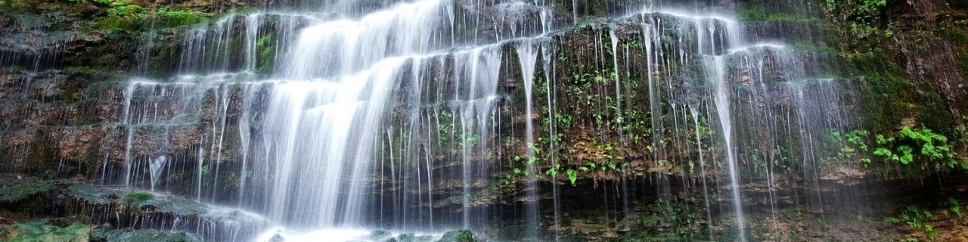 Rock Island State Park has a lot to offer. Camping, trails, and waterfalls. This waterfall is off of the old waterfall trail. It is about a half mile into the trail. The State park has a number of waterfalls this being one of the smaller ones. I don't think it has a name and also think you have to go after some rain to see it like this.