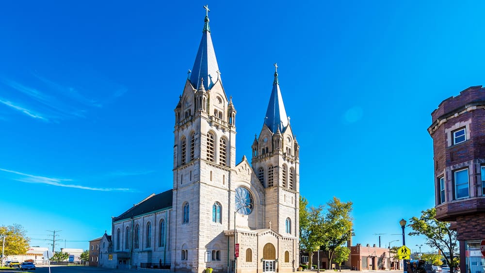 A historic church with two tall towers and a large clock.