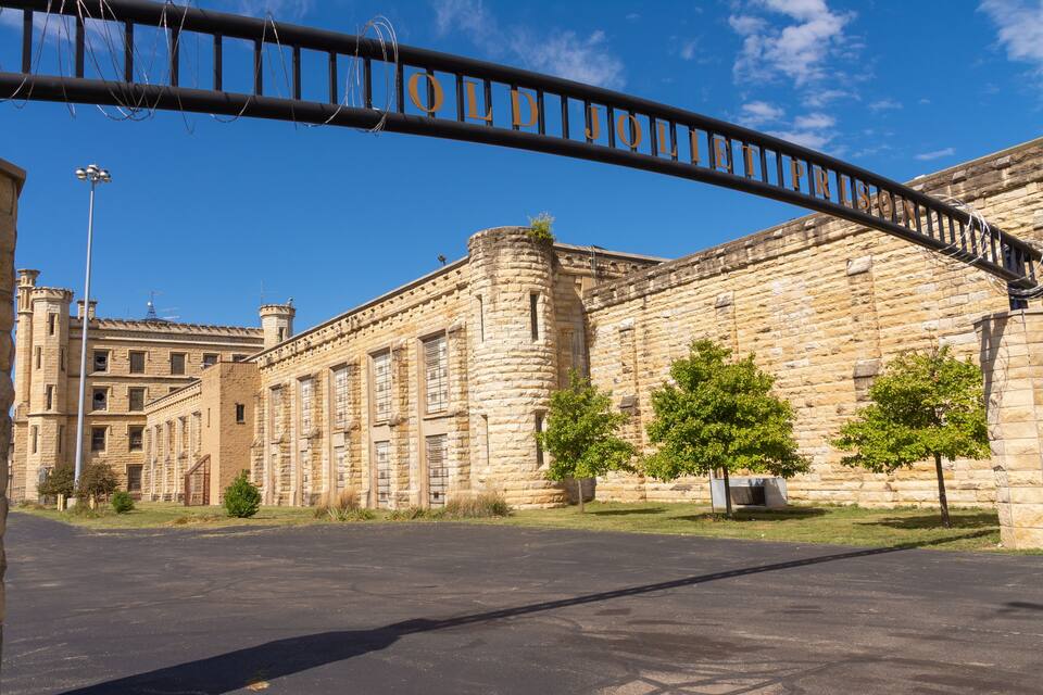 A historic stone building with a large arched entrance labeled "Old Jail."
