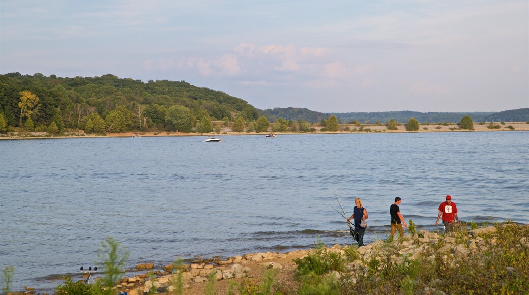 Monroe Lake showing fishing and a lake or waterhole as well as a small group of people
