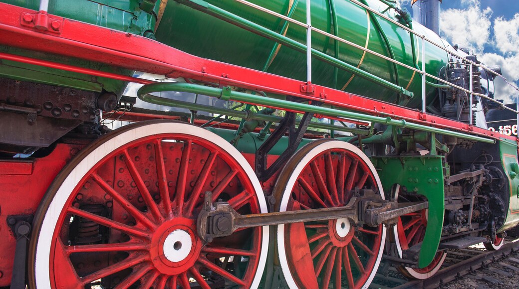 Eliminations of an old Russian steam locomotive. Black steam locomotive, red wheels.