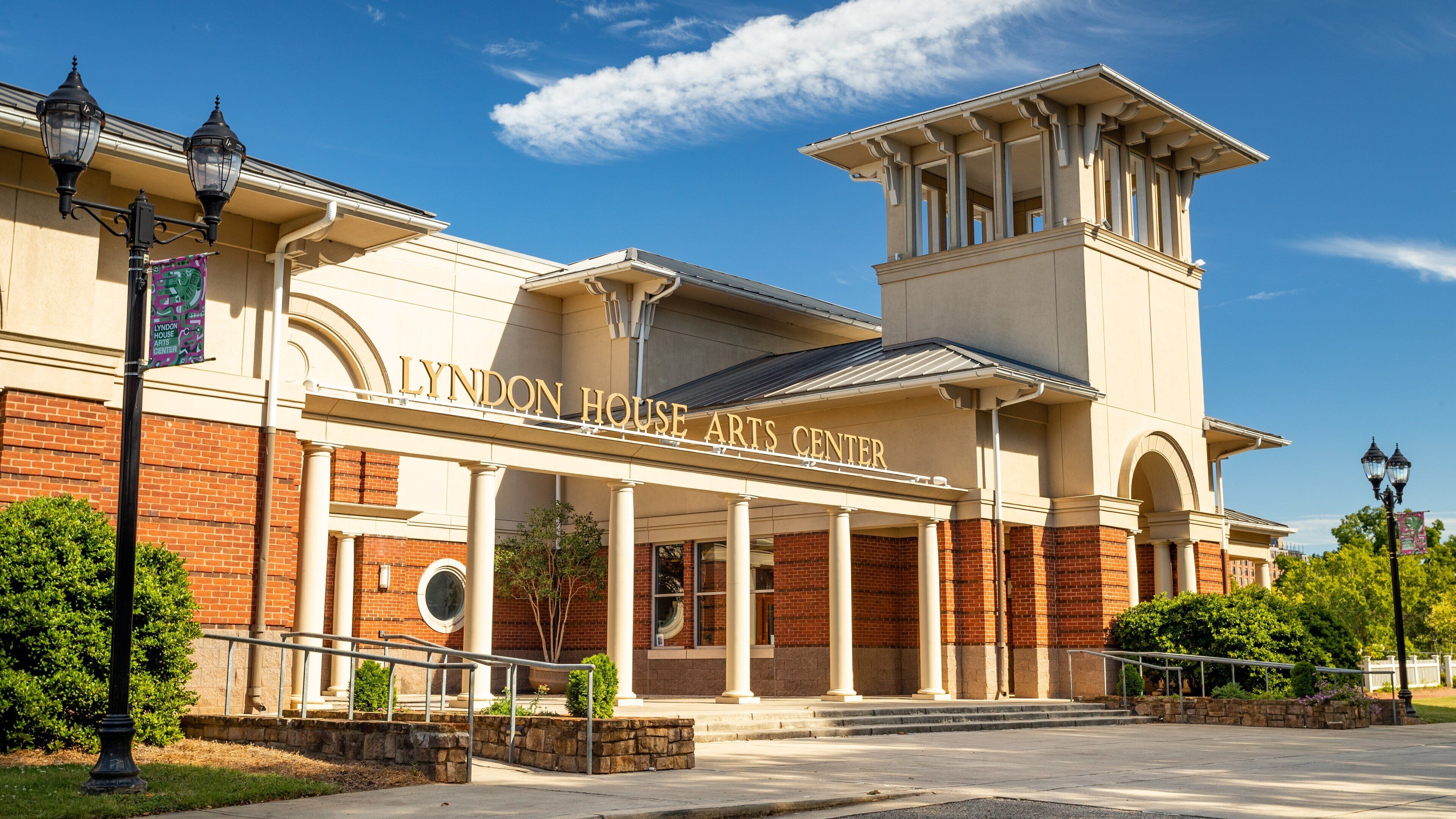 The Lyndon House Arts Center with a brick facade and a large arched entrance.