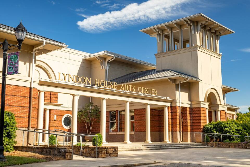 The Lyndon House Arts Center with a brick facade and a large arched entrance.