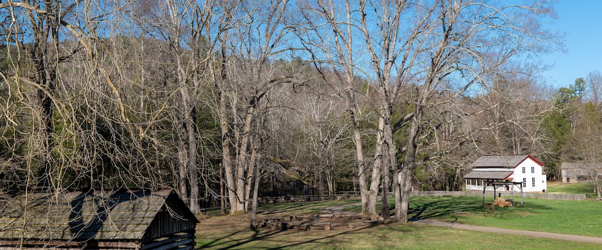 Old buildings and trees at a Cades Cove historic area in the Great Smokey Mountains.