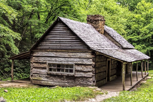 A log cabin in the woods. The Noah Bud Ogle Place was a homestead located in the Great Smoky Mountains Park near Gatlinburg, Tennessee., Shutterstock ID 175219004, Purchase Order: SP-1891 Wave 0, Clie