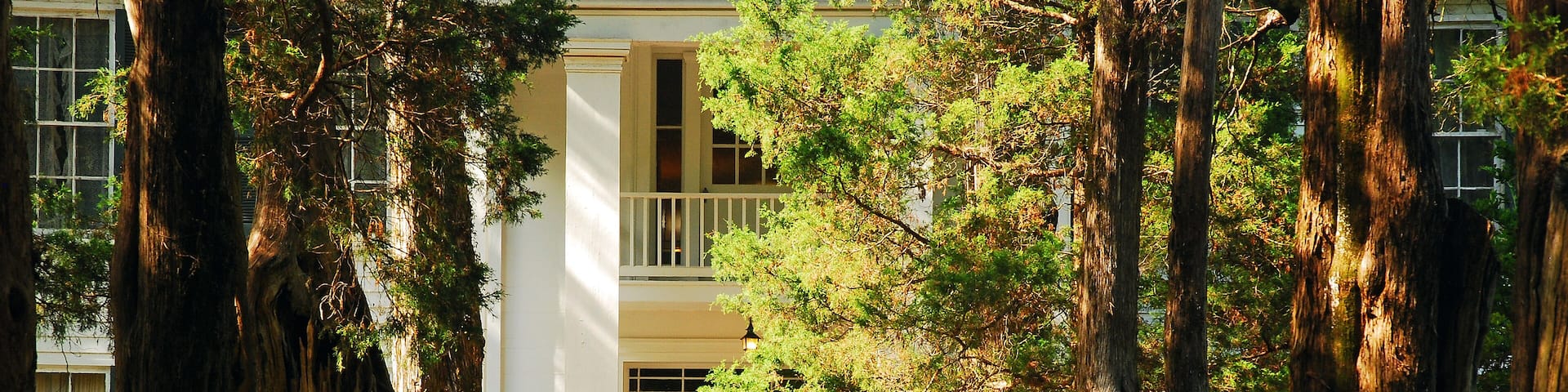 Two adult women head to the entrance of Rowan Oak, the William Faulkner House in Oxford, Mississippi