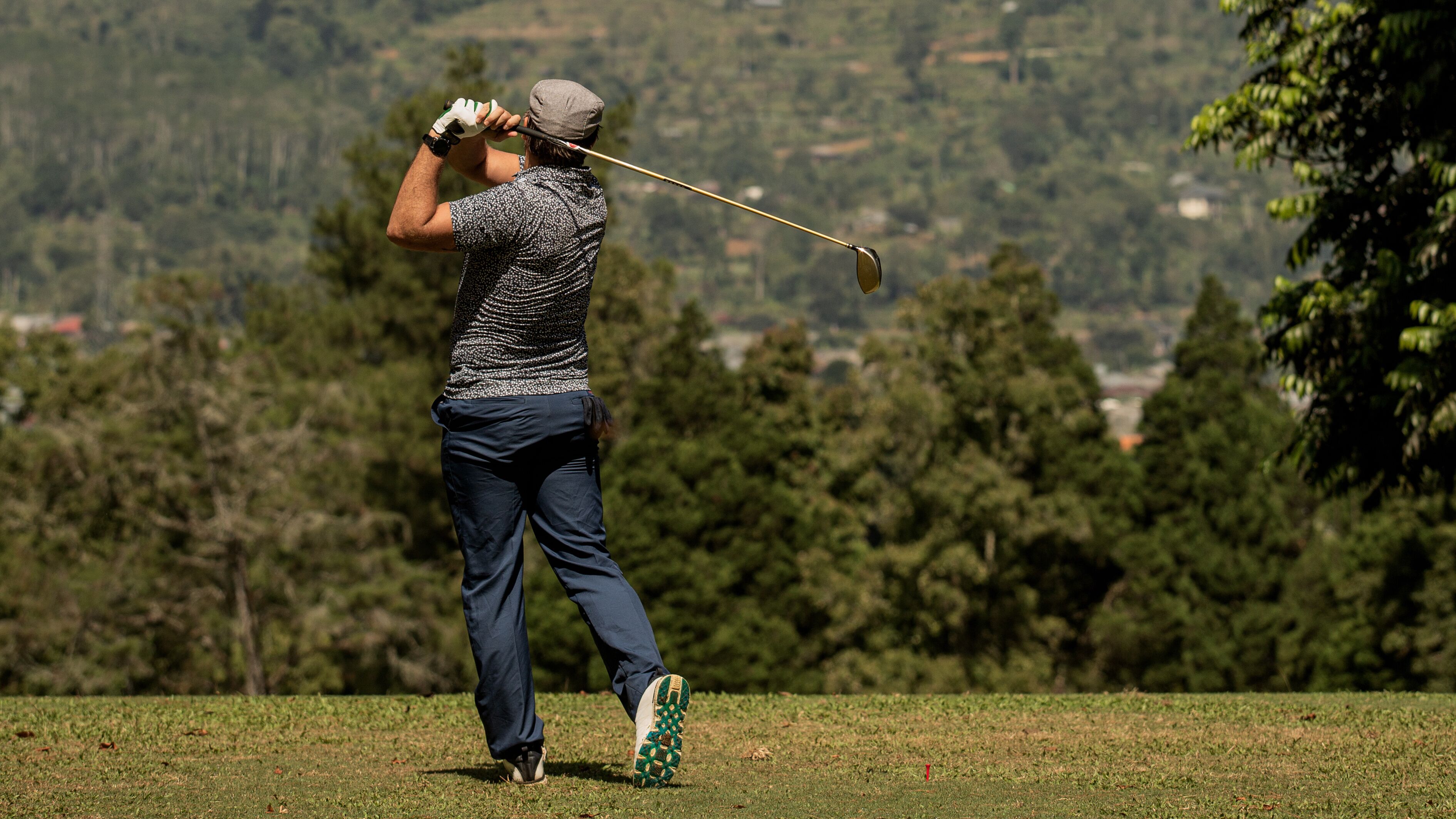A man swinging a golf club