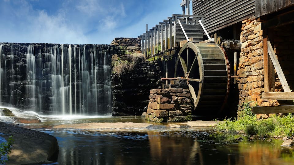 A waterfall, a wooden structure, and a water wheel.