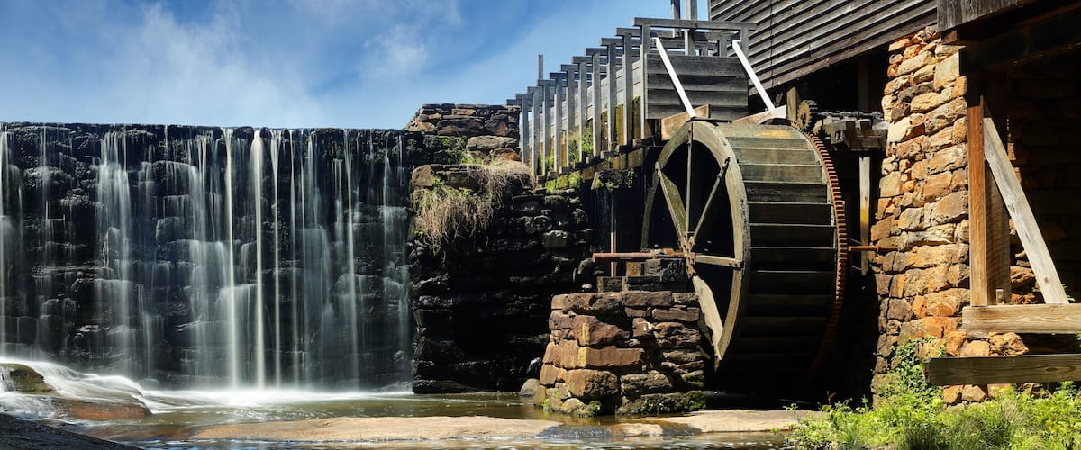 A waterfall, a wooden structure, and a water wheel.