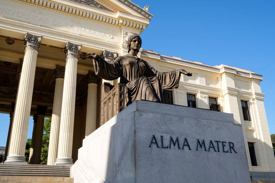 A statue of Alma Mater in front of a classical building with columns.