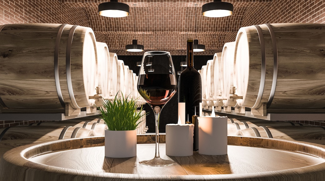 Keg with wine bottle in brick cellar interior