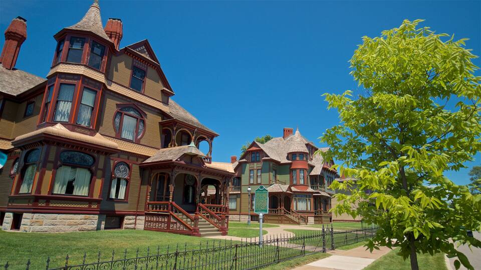 A large, ornate Victorian-style house with multiple towers and intricate woodwork.