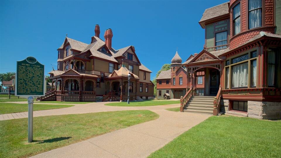 A historic house with a large porch and a gazebo.