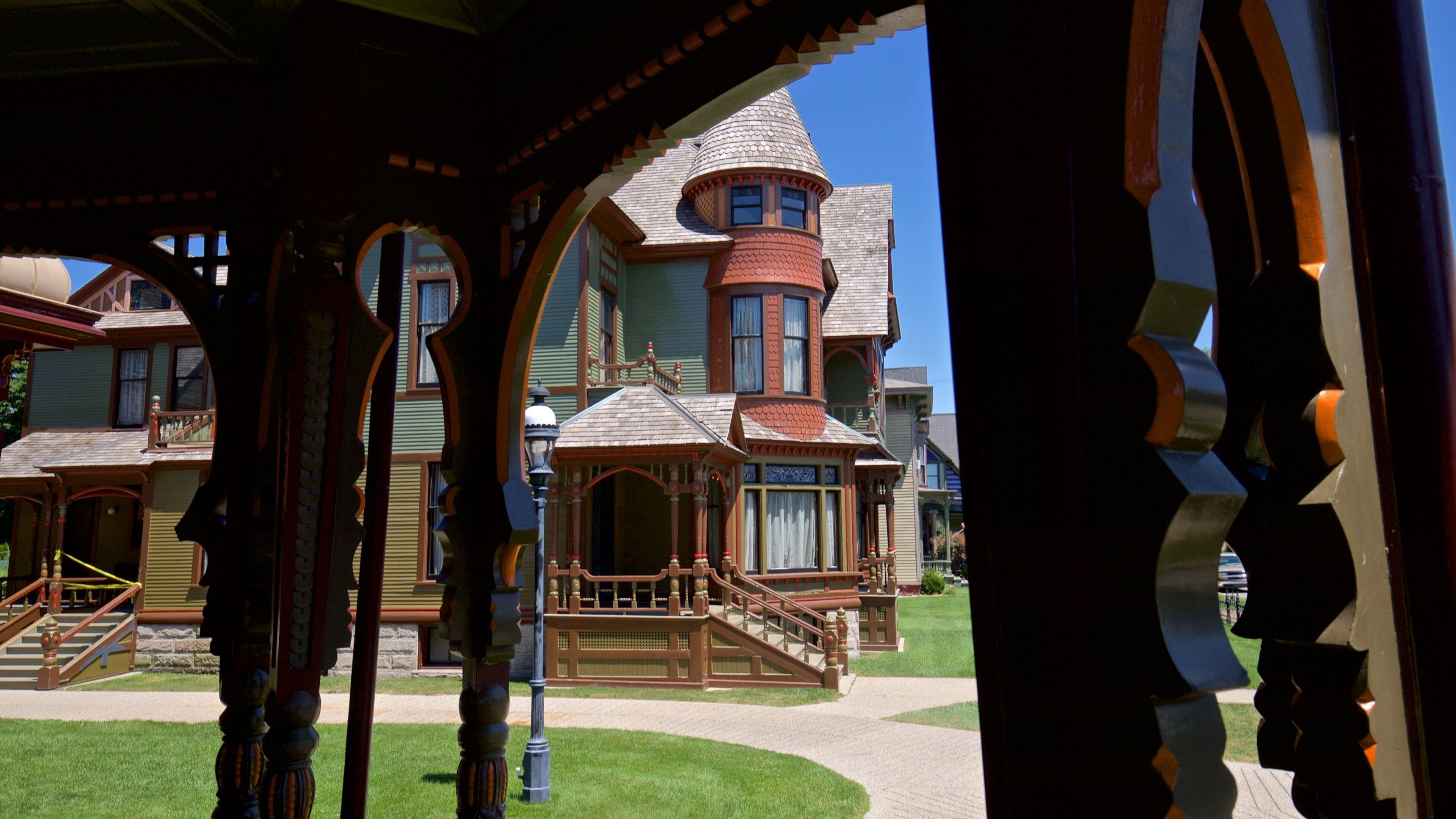 A Victorian-style house with a turret and a wrap-around porch.