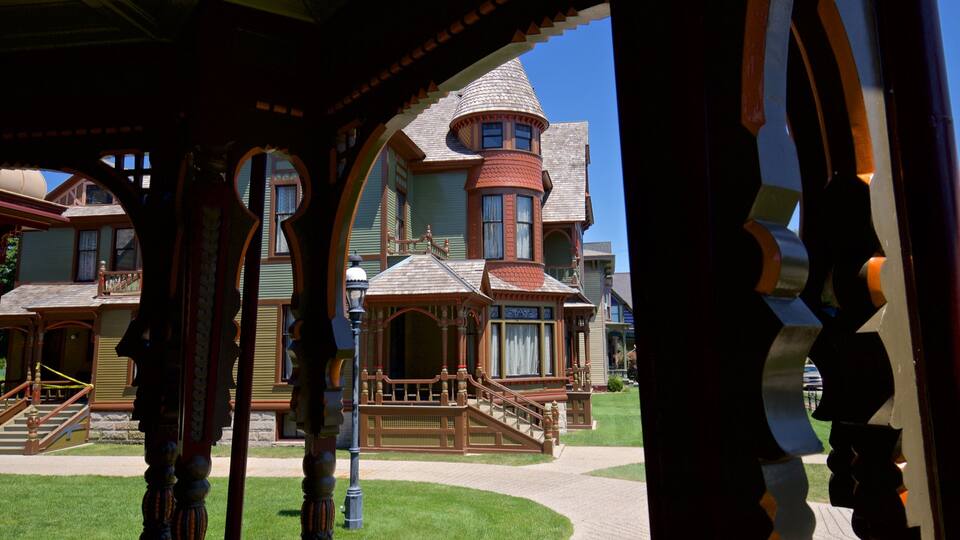 A Victorian-style house with a turret and a wrap-around porch.