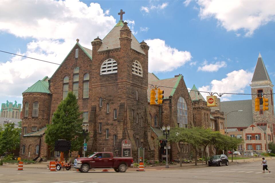 A historic church with a prominent steeple and a cross on top.
