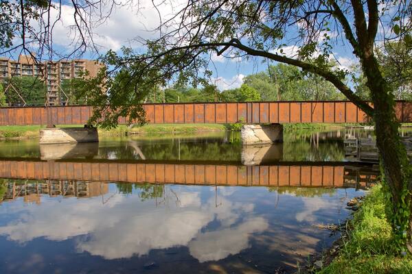 Adado Riverfront Park which includes a river or creek and a bridge