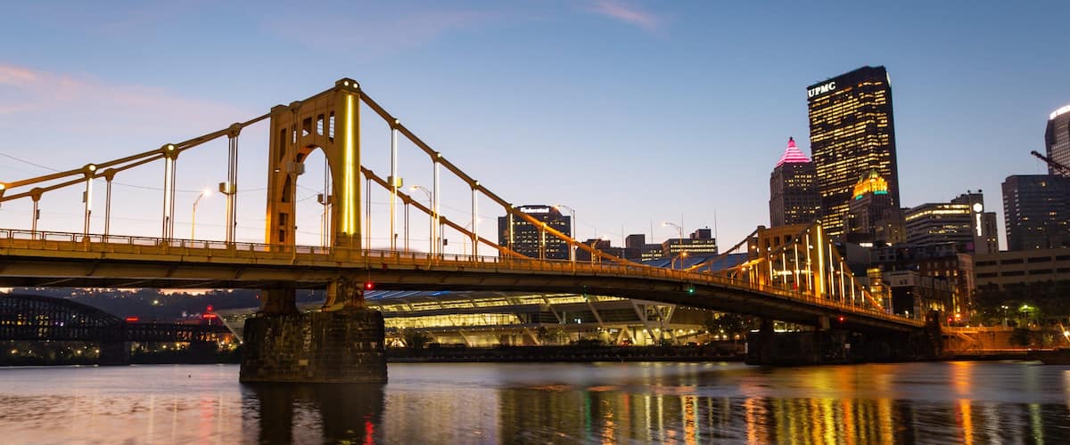 Three Rivers Heritage Trail which includes a bridge, a city and a sunset