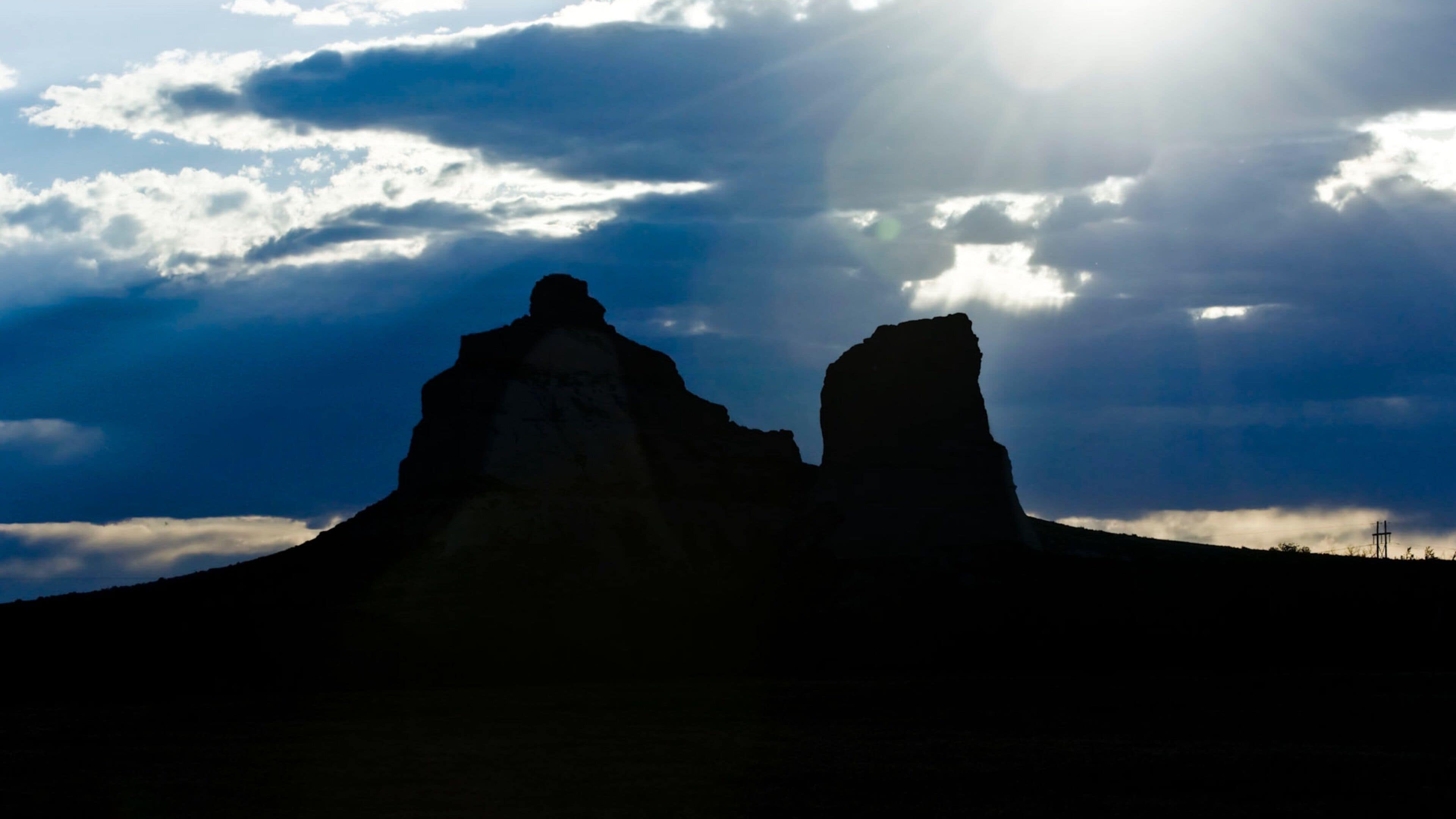 Courthouse and Jail Rocks featuring skyline, mountains and a sunset