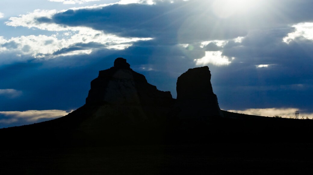 Courthouse and Jail Rocks featuring skyline, mountains and a sunset