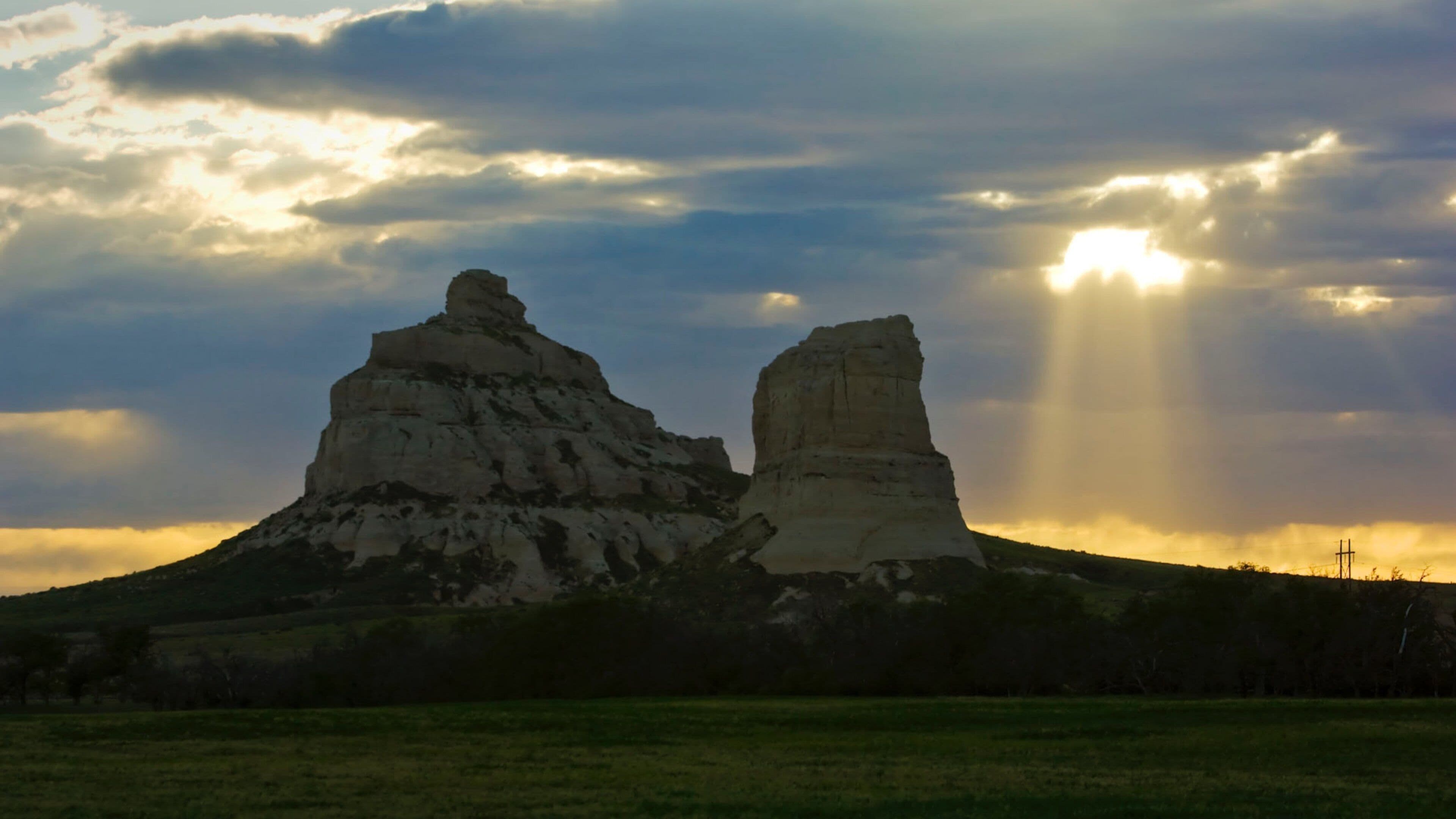 Courthouse Rock which includes a sunset and mountains