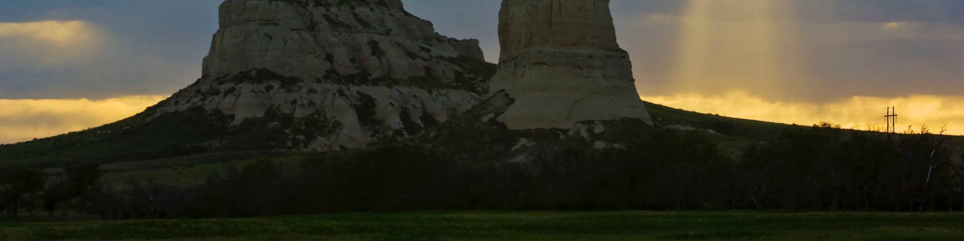 Courthouse Rock which includes a sunset and mountains