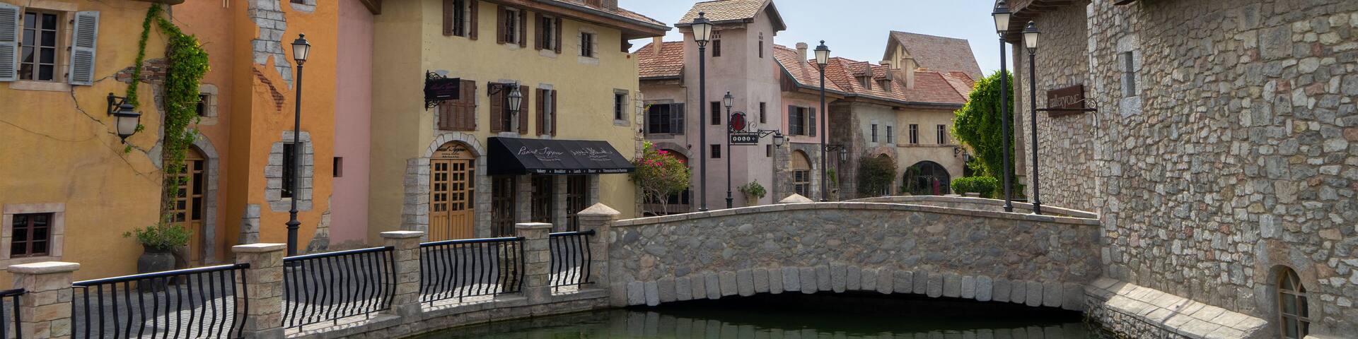Walking area with shops and restaurants in United Arab Emirates. Riverland, Dubai. Houses in style of medieval Europe