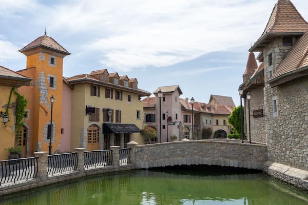 Walking area with shops and restaurants in United Arab Emirates. Riverland, Dubai. Houses in style of medieval Europe