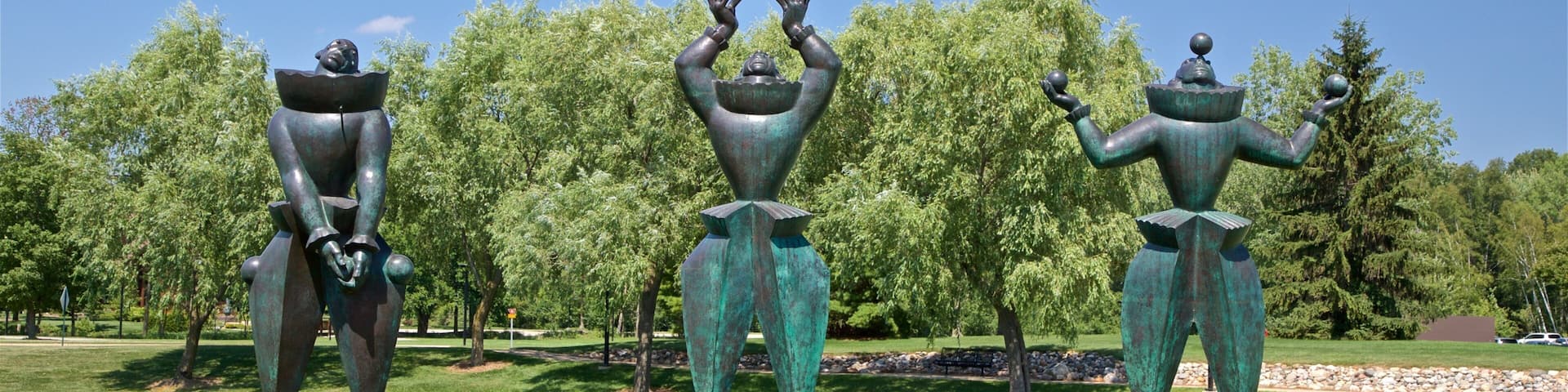 Marshall M. Fredericks Sculpture Museum showing a statue or sculpture, a lake or waterhole and outdoor art