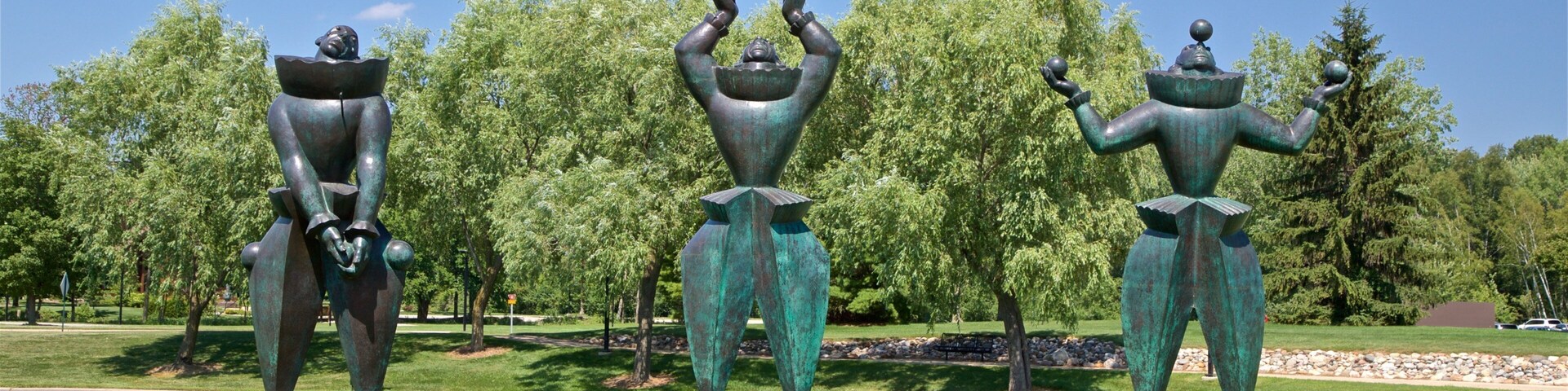 Marshall M. Fredericks Sculpture Museum showing a statue or sculpture, a lake or waterhole and outdoor art
