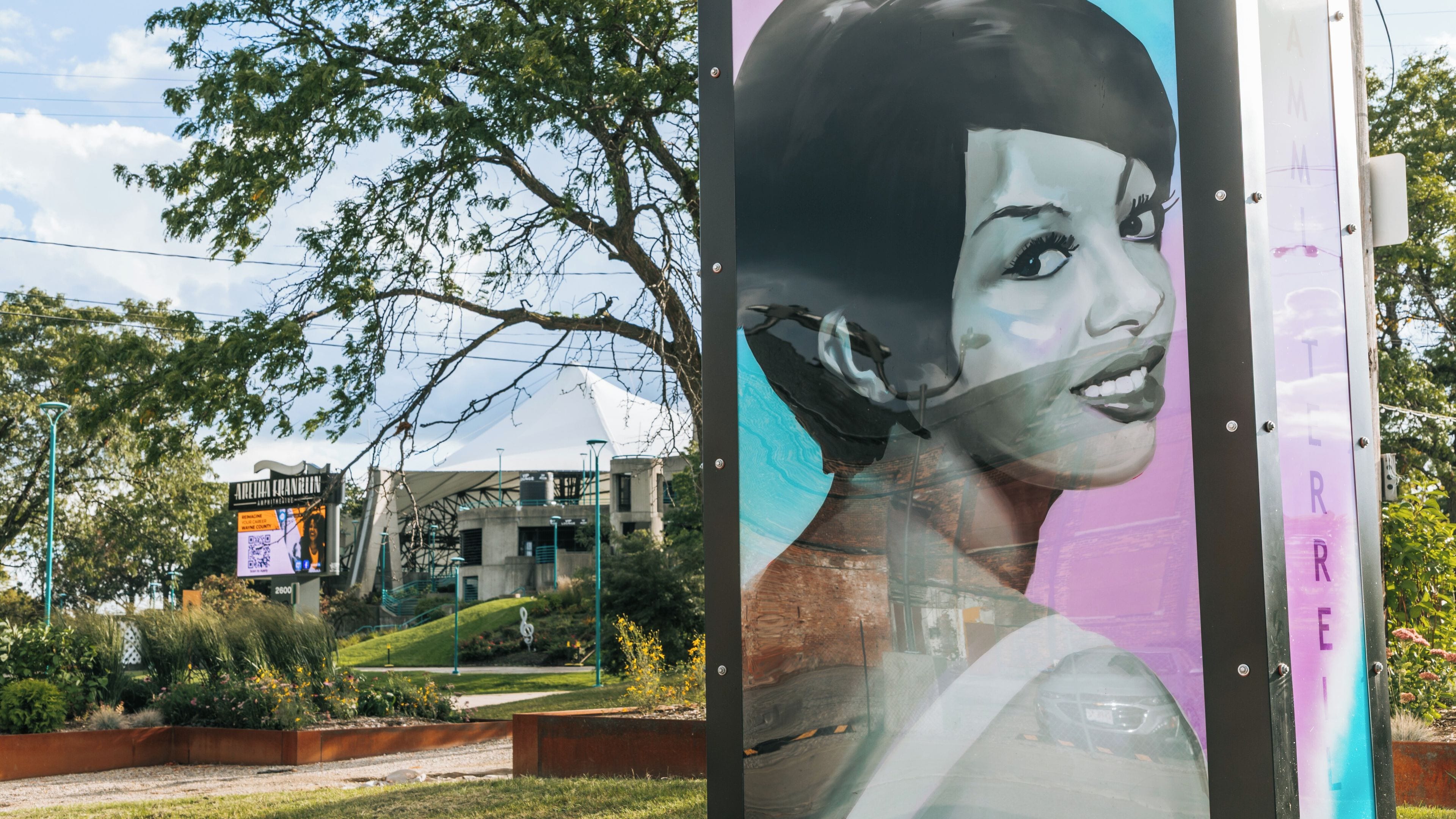A billboard with a partial view of a building in the background.