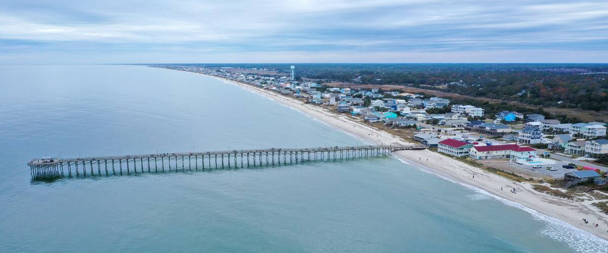 Aerial view of Ocean crest fishing pier at Oak Island NC. Looking at the pier and beach front.