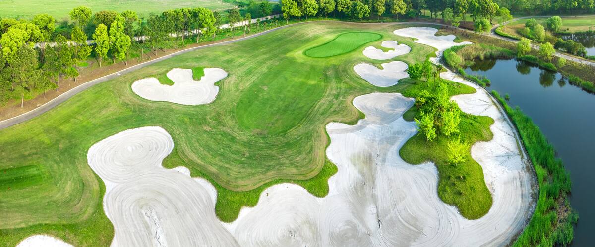 Aerial view of golf course and lake nature scenery