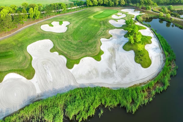 Aerial view of golf course and lake nature scenery