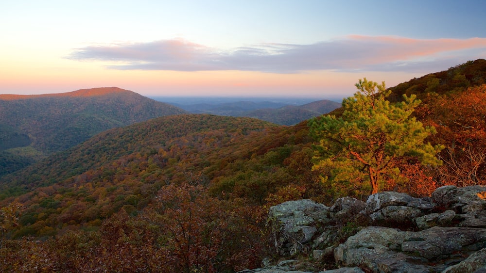 A mountainous landscape with autumn foliage and a clear sky.