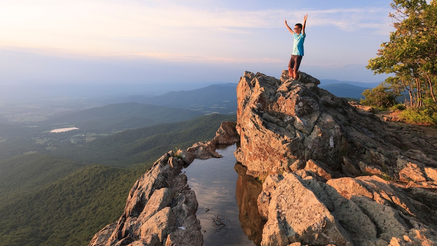 A teenager standing on the edge of a cliff