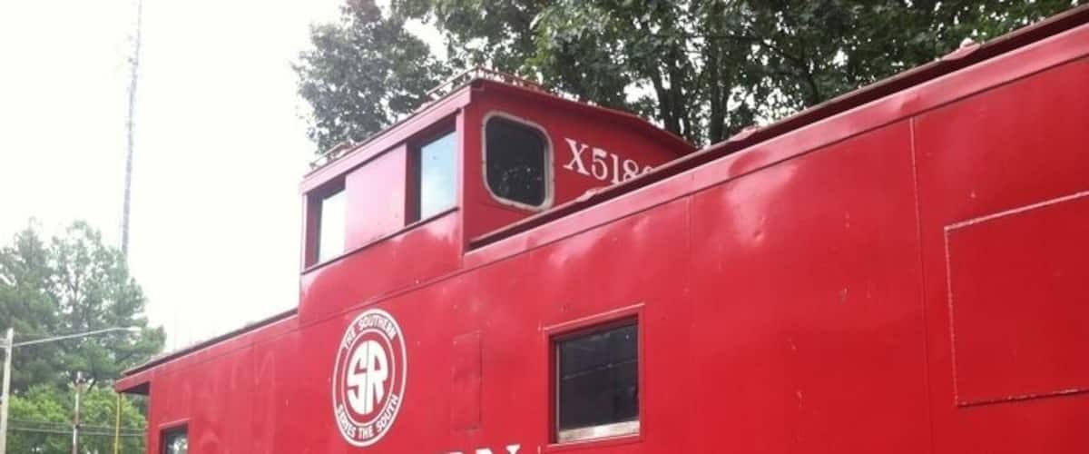 A red Southern Washington train car with the number X518606.