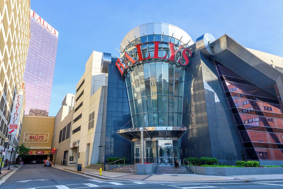 A modern building with a glass facade and the sign "BALLYS" prominently displayed.