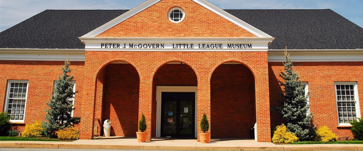 A brick building with a sign reading "Peter J. McGovern Little League Museum."