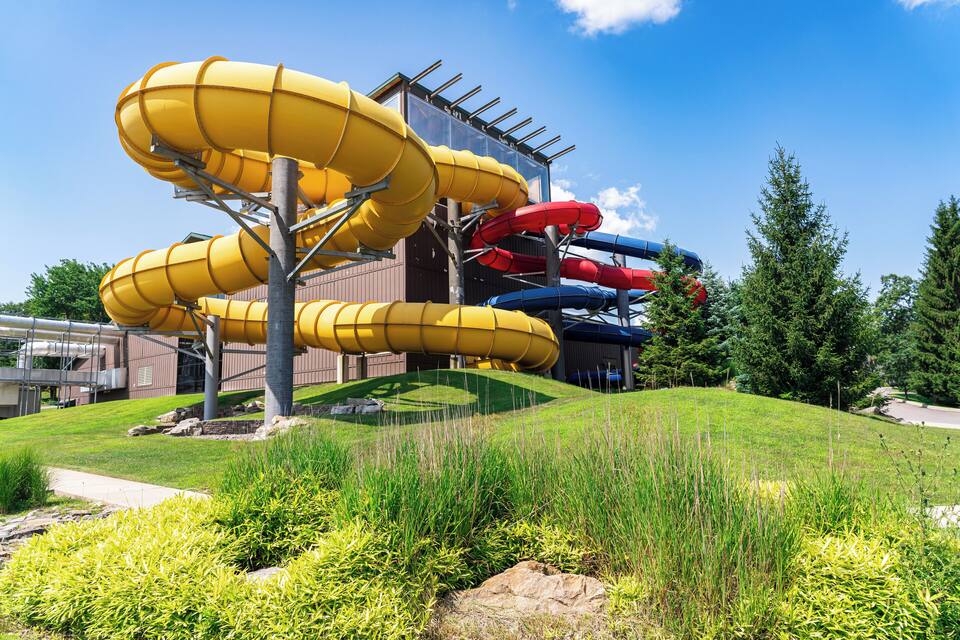A water park with multiple slides in yellow, red, and blue.