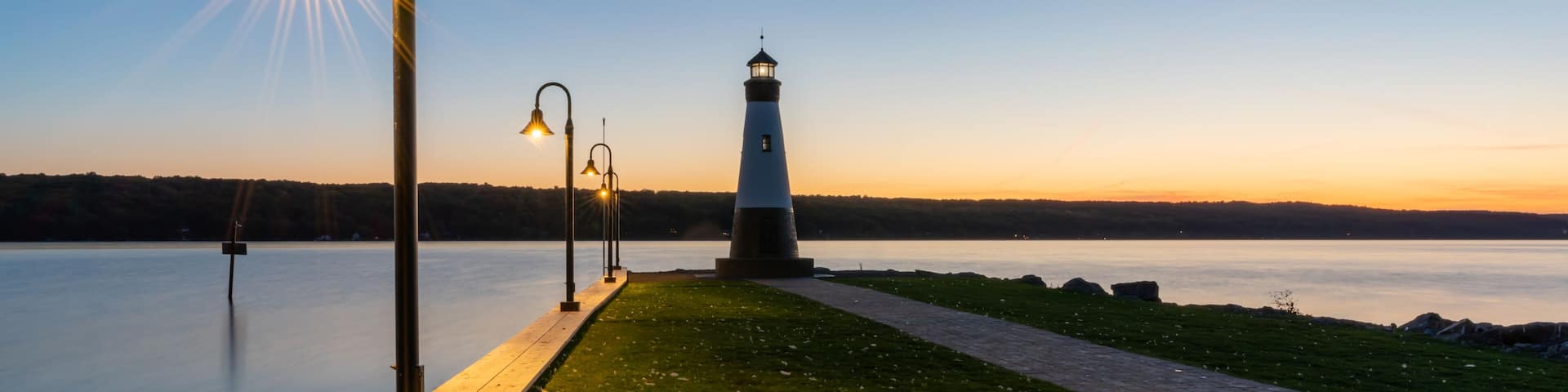 Sunset photo of the Myers Point Lighthouse at Myers Park in Lansing NY, Tompkins County. The lighthouse is situated on the shore of Cayuga Lake, near Ithaca New York.