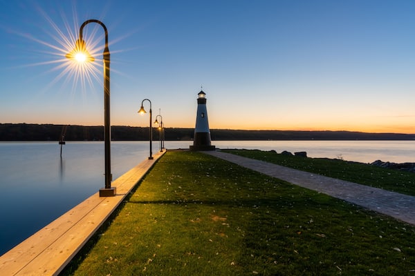 Sunset photo of the Myers Point Lighthouse at Myers Park in Lansing NY, Tompkins County. The lighthouse is situated on the shore of Cayuga Lake, near Ithaca New York.