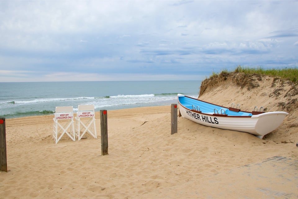 A beach with a boat named "Hither Hills" and two chairs with signs reading "KEEP OFF LIFEGUARDS ONLY".