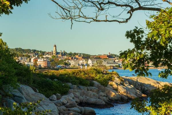 Stage Fort Park which includes a coastal town and rocky coastline