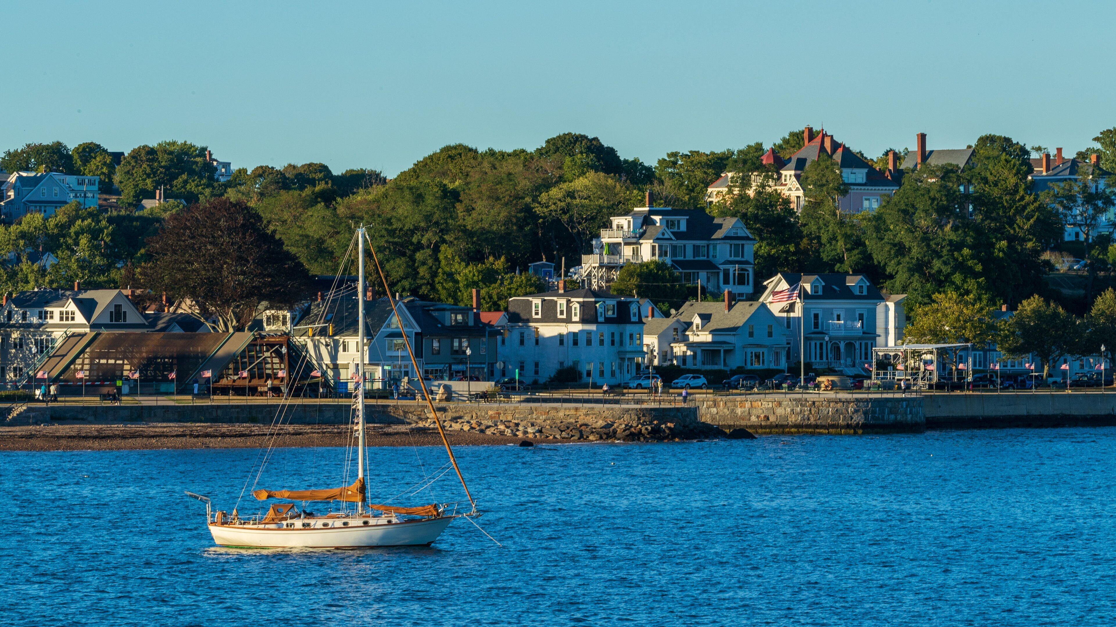 Stage Fort Park showing a bay or harbor, sailing and a coastal town