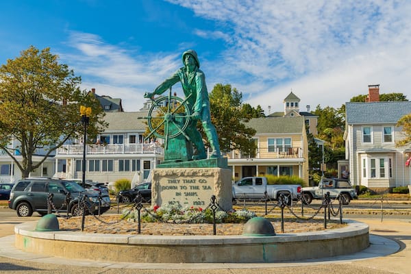 Fishermen\'s Memorial Monument featuring a statue or sculpture and a small town or village