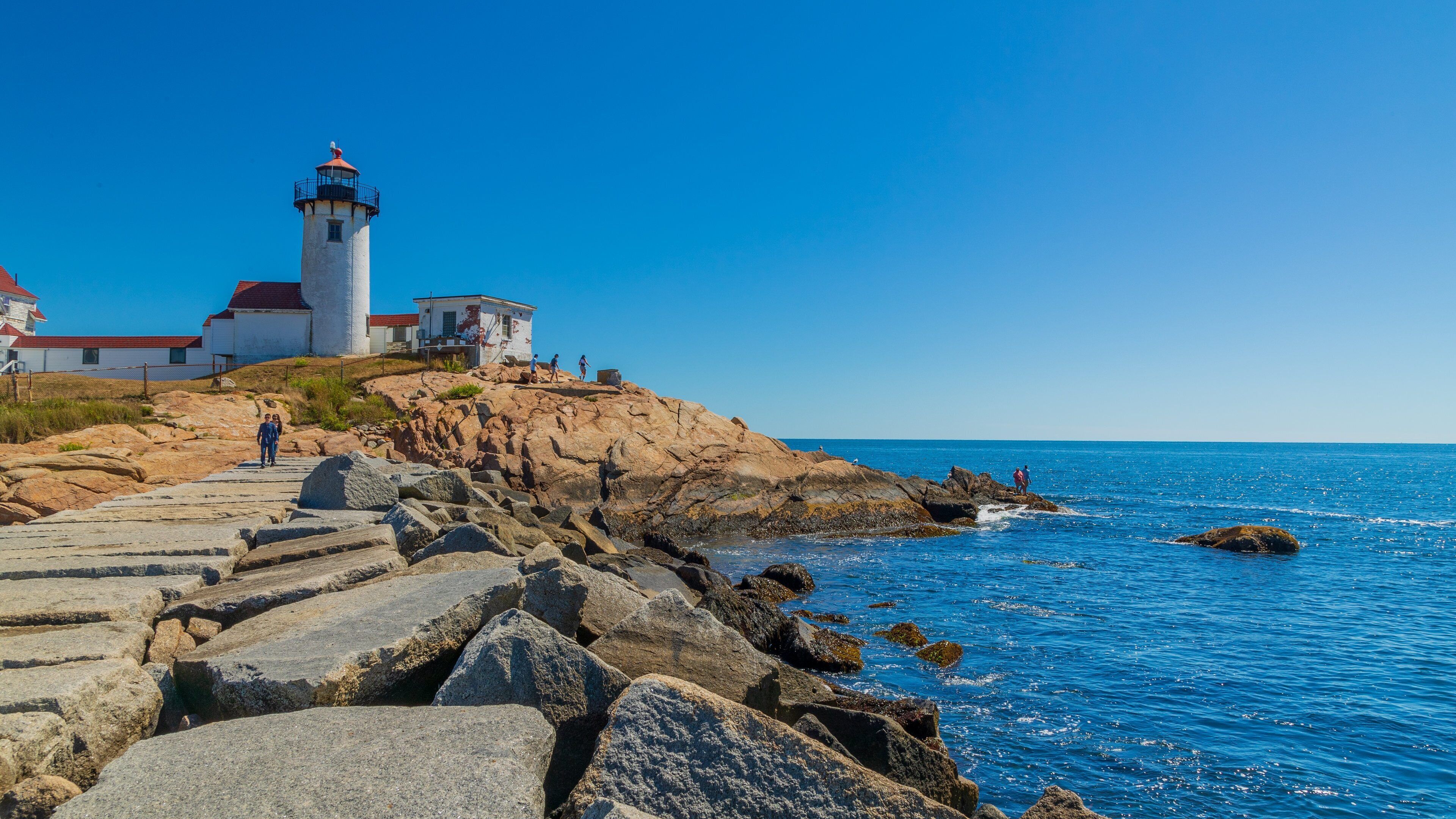 Eastern Point Lighthouse which includes general coastal views, a lighthouse and rocky coastline
