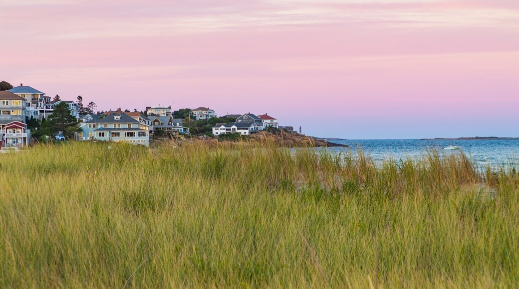 Good Harbor Beach which includes a sunset and a coastal town