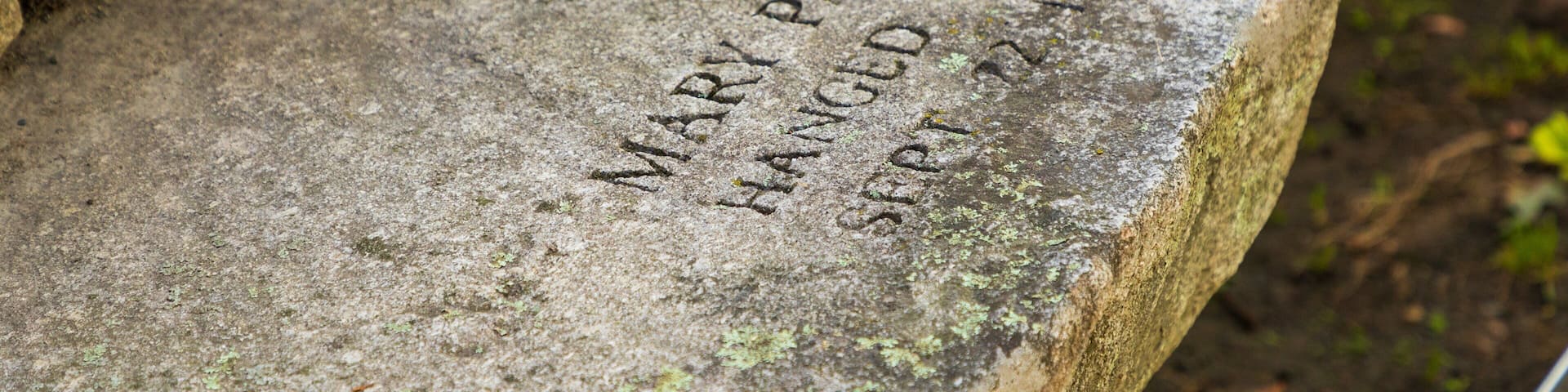A stone with engraved names and dates.